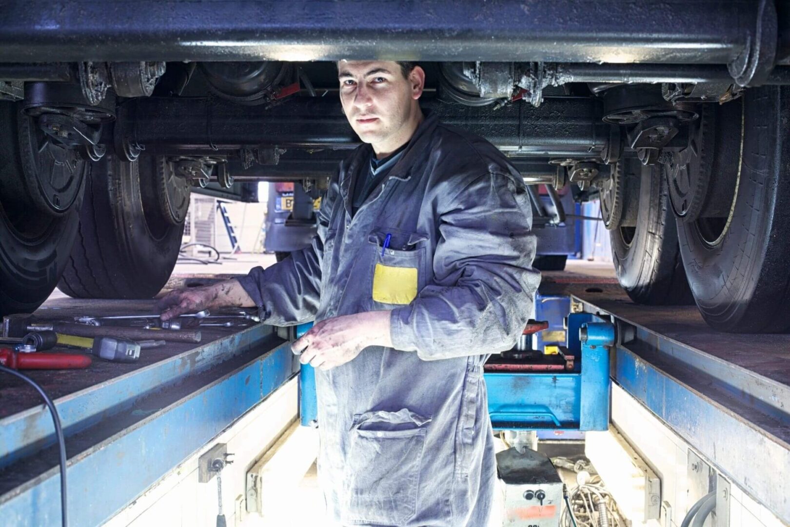 A man standing in front of an engine compartment.